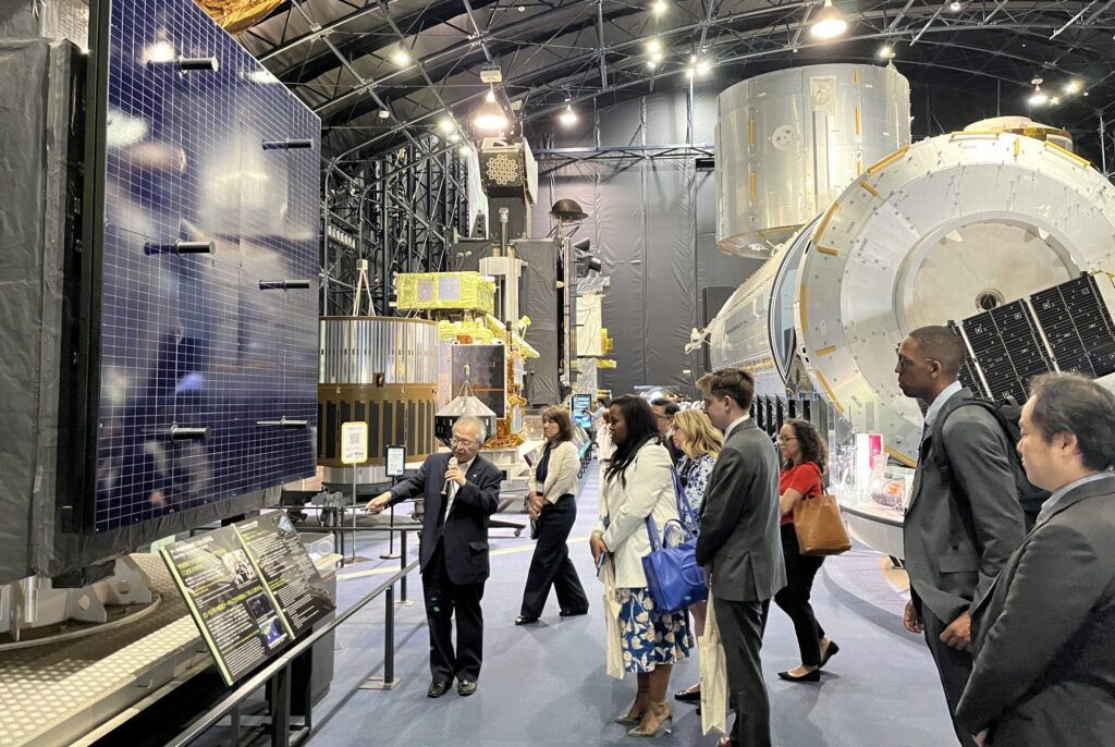 A JAXA official offers a guided tour of the space museum.