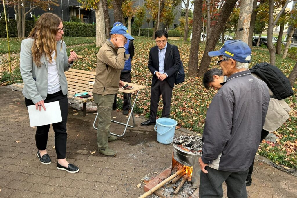 Enjoying roasted sweet potatoes with members of the senior citizen association's gardening group
